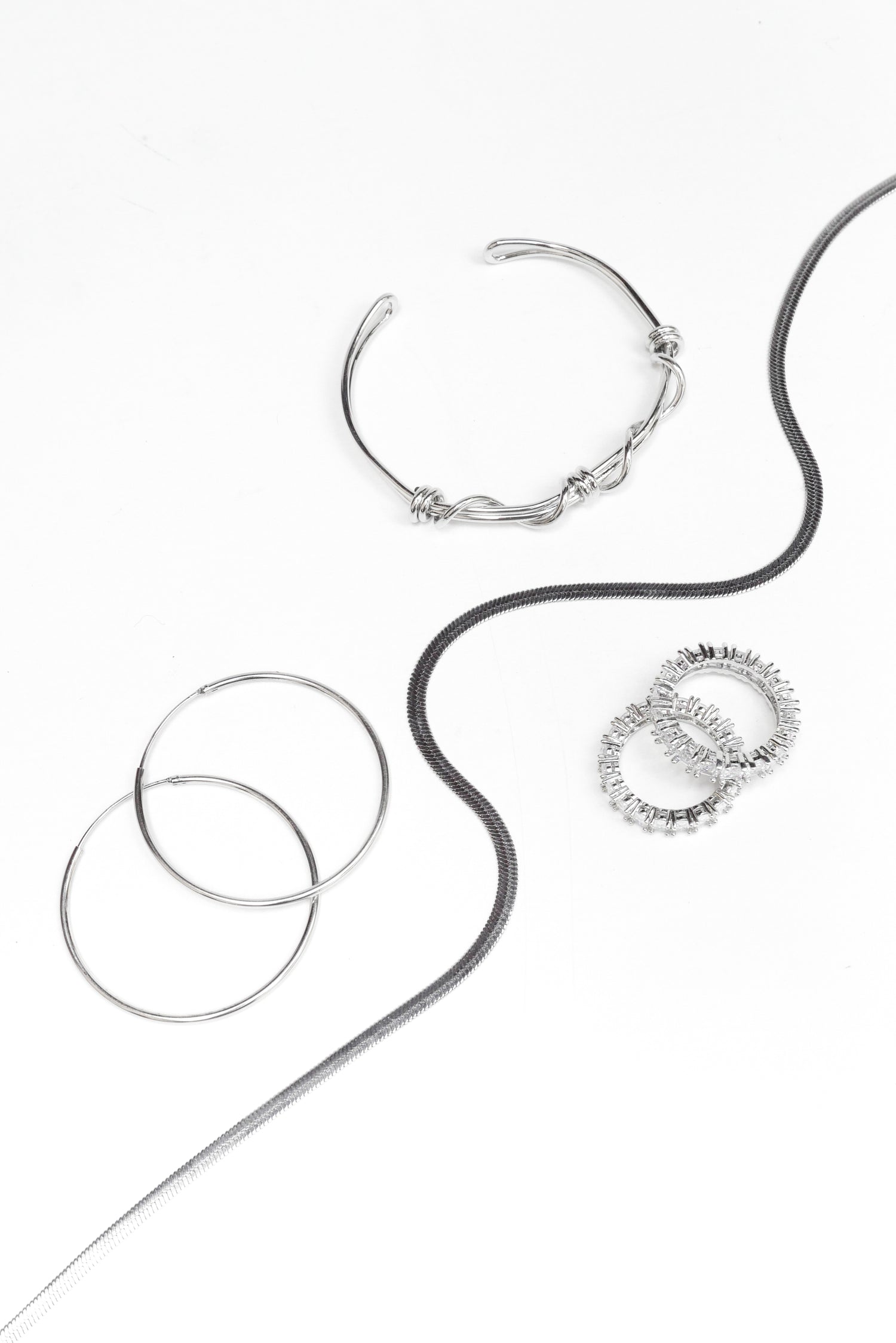 .925 Silver Earrings, Necklace, Bracelet and Crystal Rings on Flat display