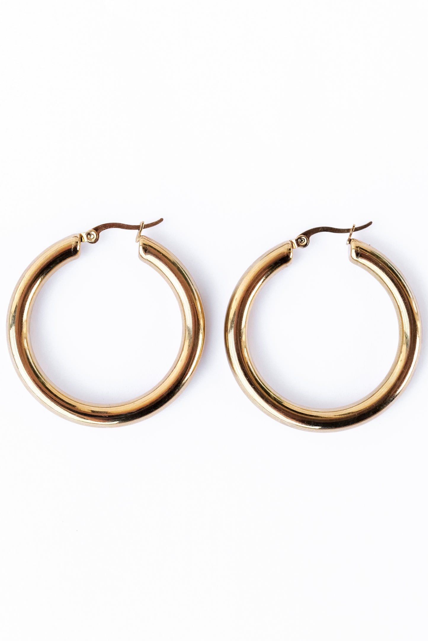 Medium staple Hoop earrings against a white backdrop