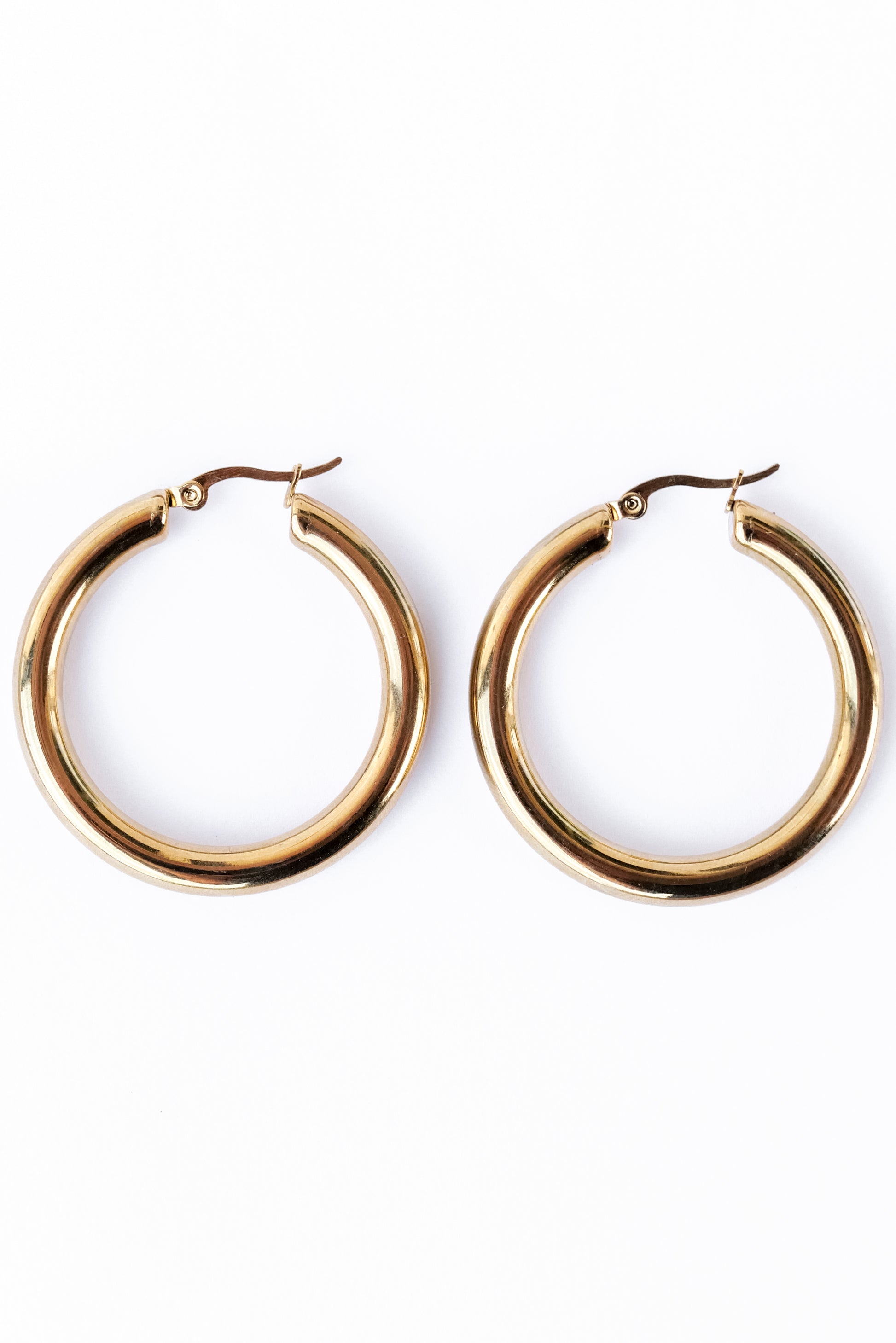 Medium staple Hoop earrings against a white backdrop