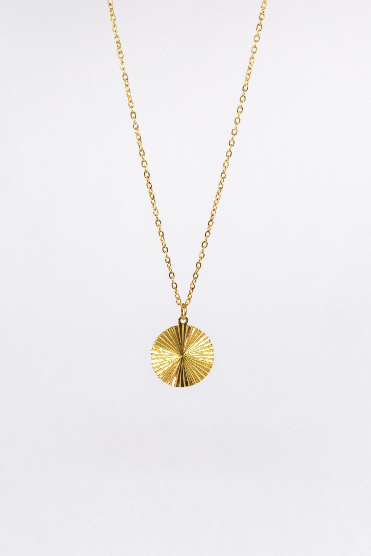 Medallion necklace on white backdrop 