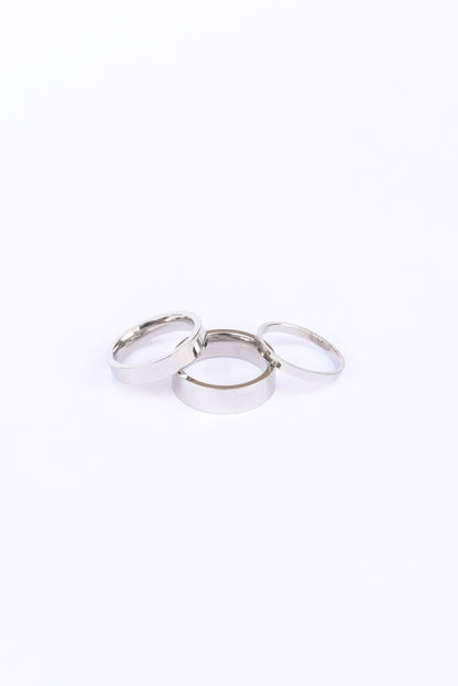 Silver banded Amor ring set on a white backdrop