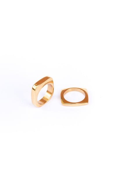 Two out of the box rings on a white backdrop one lays flat while the other stands on its side